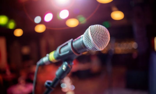 Public performance on stage Microphone on stage against a background of auditorium. Shallow depth of field.
