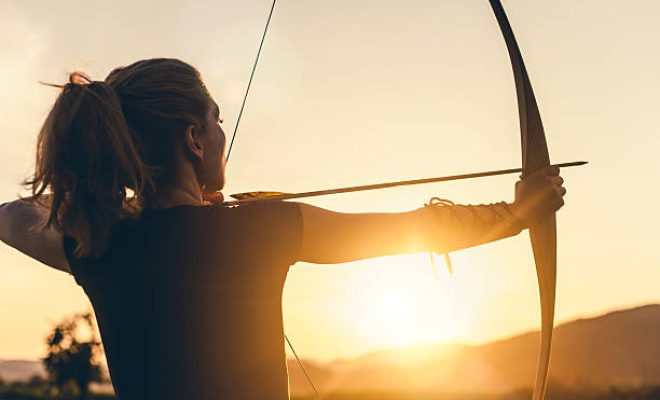 Woman shooting with the longbow